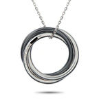 Circular white gold and black ceramic pendant with engraved inner band