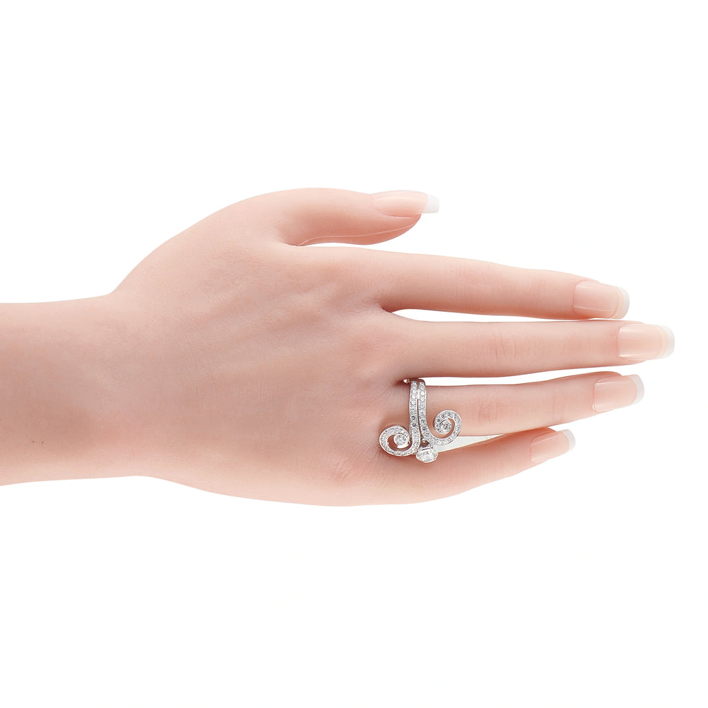 Cartier 18K white gold diamond ring with swirl design on a hand