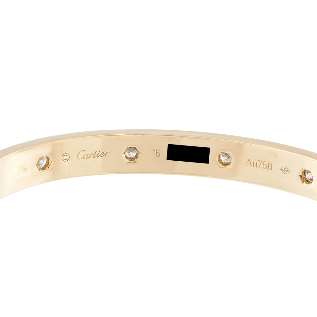 Inside of the gold bracelet showing diamond settings and Cartier hallmarks