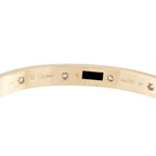 Inside of the gold bracelet showing diamond settings and Cartier hallmarks