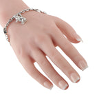Cartier animal charm bracelet worn on hand, linked chain with small hanging charms