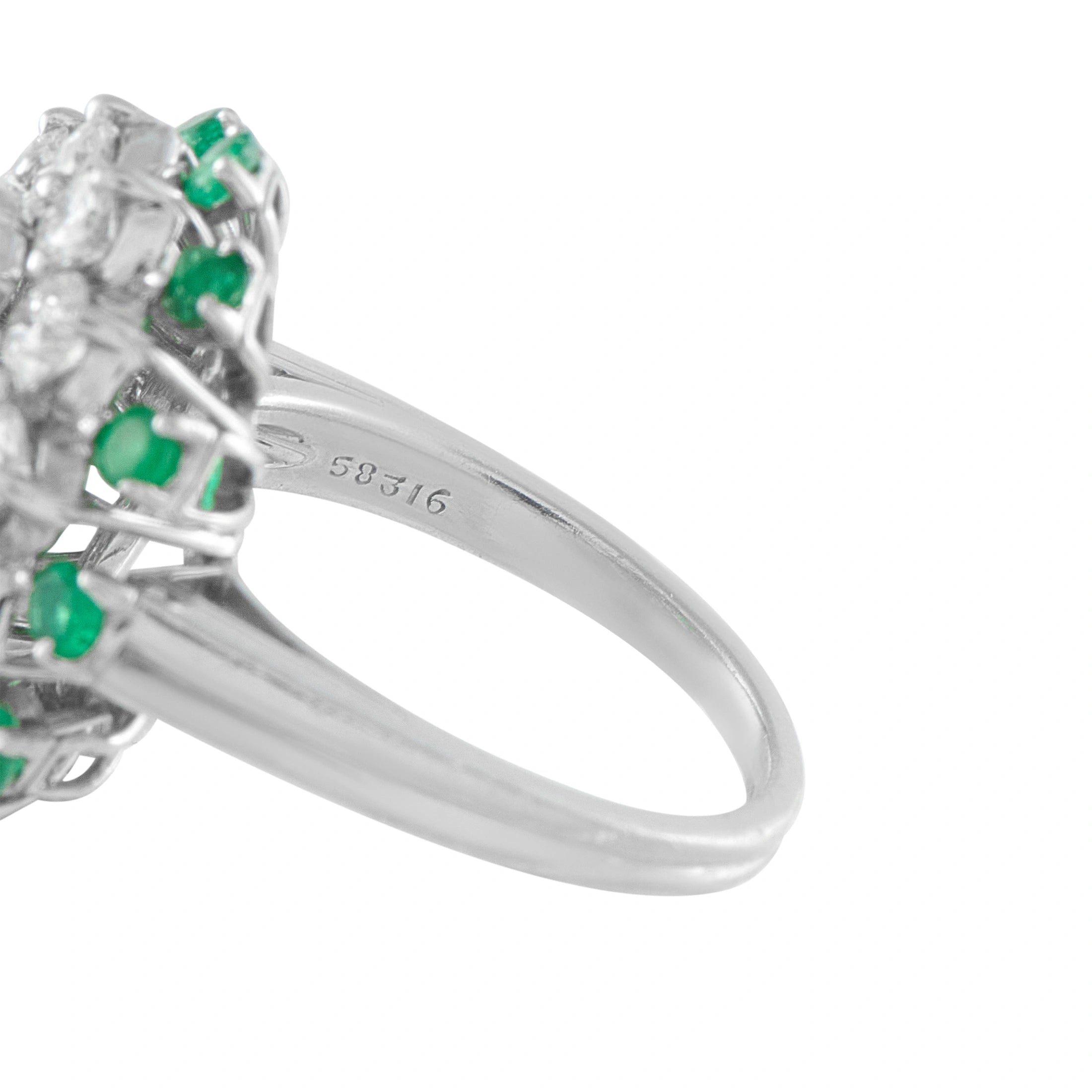 Platinum ring with 585/16 marking and emerald-diamond cluster setting