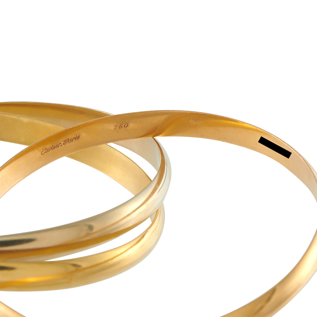 Tri-color 18K gold bangle with 750 marking and smooth triple-band design