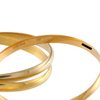 Tri-color 18K gold bangle with 750 marking and smooth triple-band design