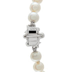 White pearl drop earrings with Chanel logo charm marked Au750 and metal details