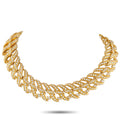 Gold wave-link choker necklace with diamond-inlaid links, arched profile