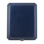 Chaumet navy jewelry box with gold trim and brand label