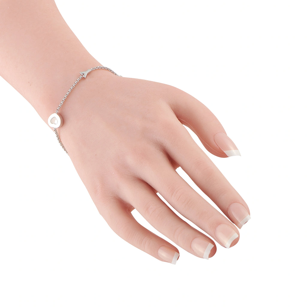 18K white gold bracelet with heart charm and diamond accents worn on wrist