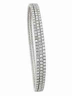 Triple-row diamond bangle bracelet with pave settings and rounded edges.