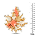 David Webb gold, diamond and coral brooch shown beside a ruler for scale
