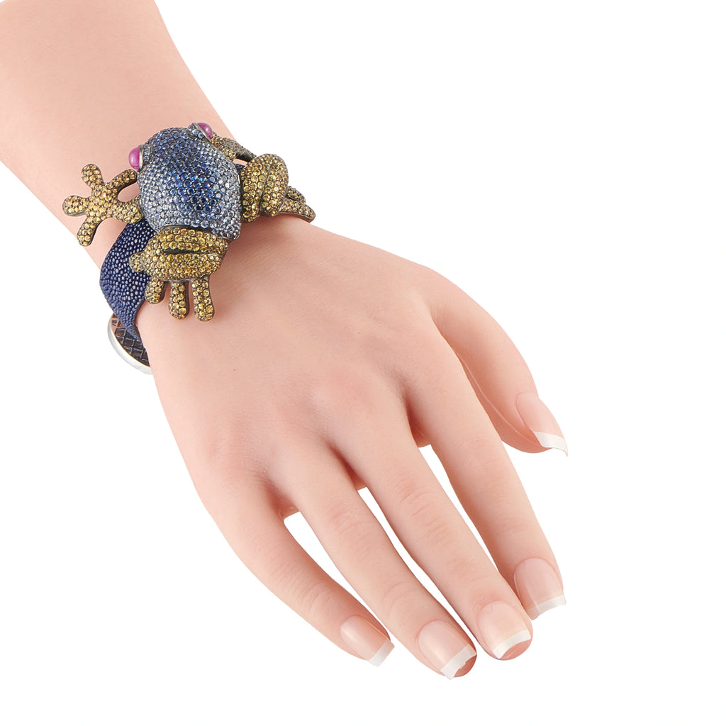 Frog rhinestone bracelet on wrist, blue stones with gold-toned frog charm