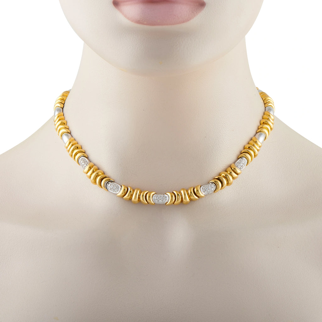 Yellow gold necklace on model with alternating ribbed beads and round diamond insets