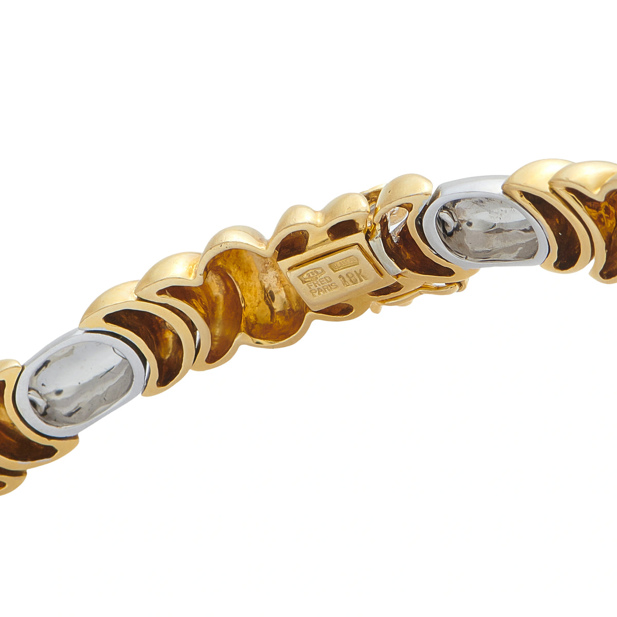 Gold clasp detail with engraved maker mark and round diamond settings in bezel