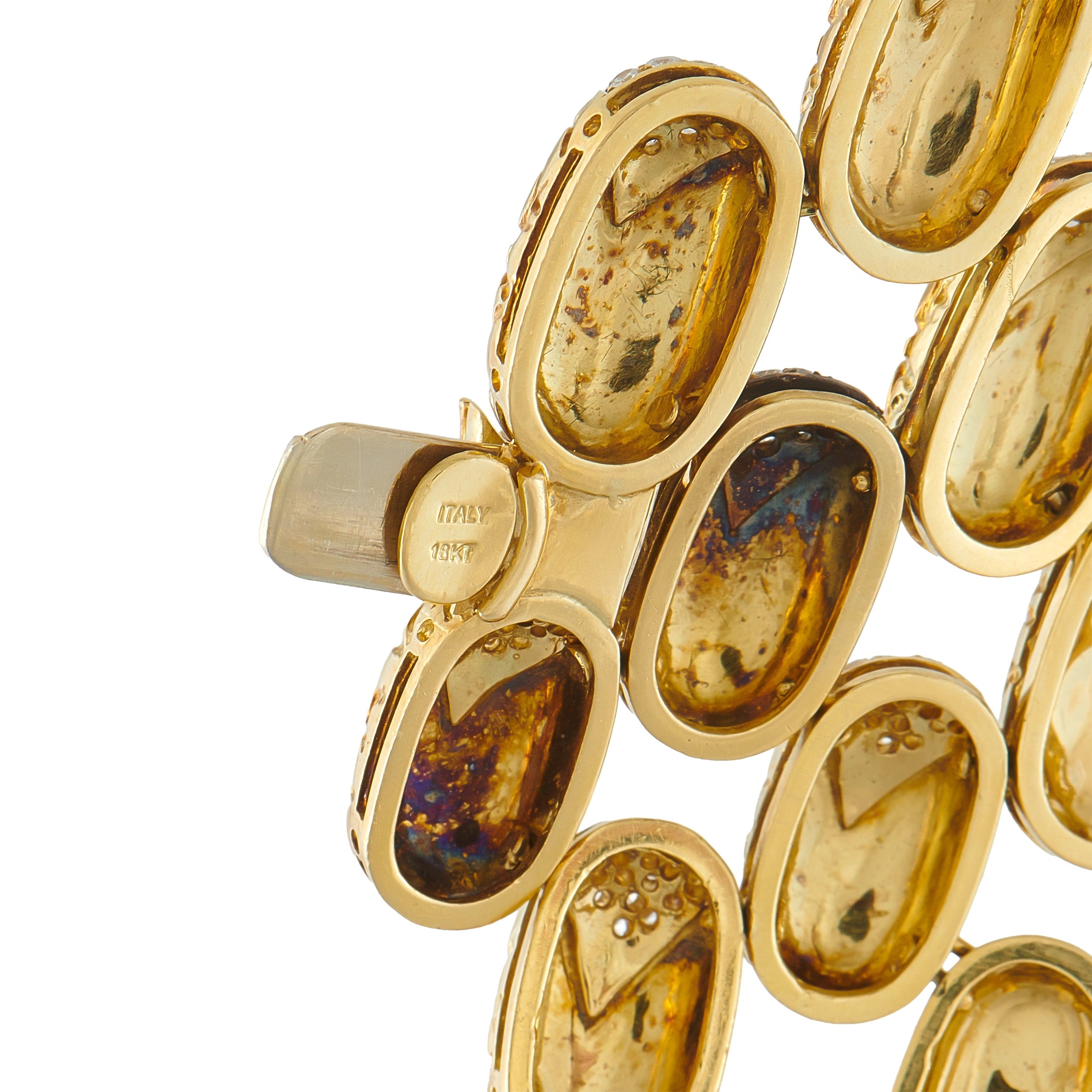 Gucci gold bracelet links with oval shapes, dark insets, and engraved stamp