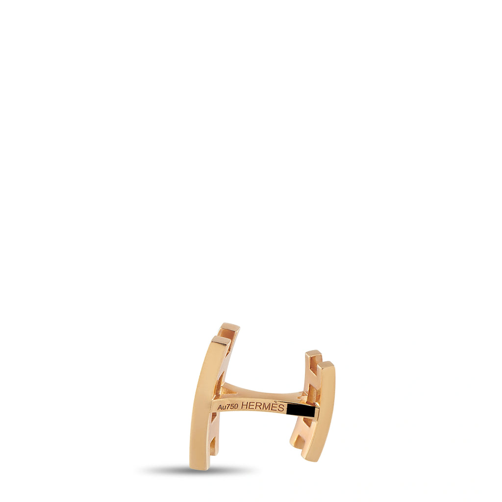 Rose gold cufflinks with open-back design and 'HERMES' engraving on bar