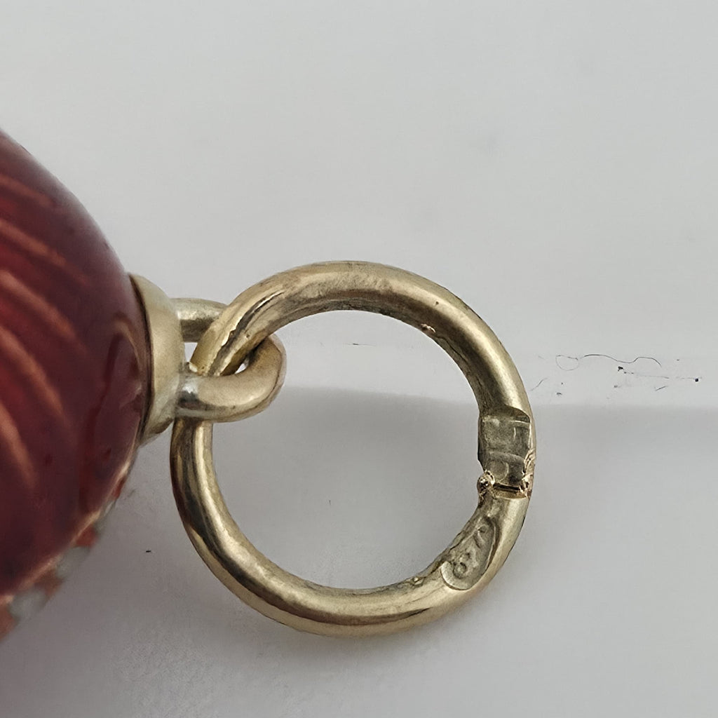 Antique yellow gold egg pendant bail loop with circular opening and maker stamp