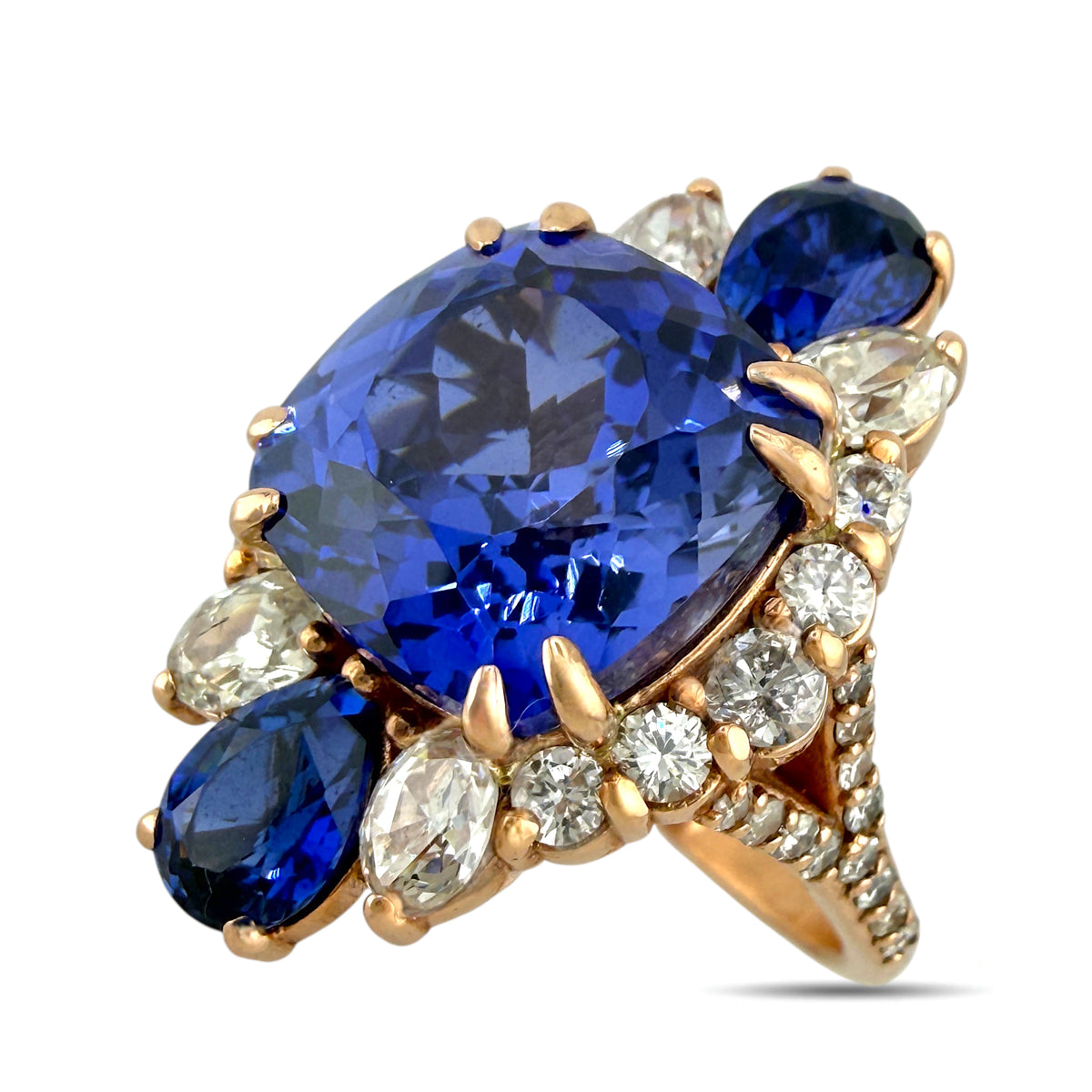 Rose gold ring with large blue sapphire, round diamonds, and marquise side stones