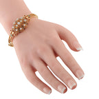 14K yellow gold diamond bracelet on wrist with enamel star motifs and round stones