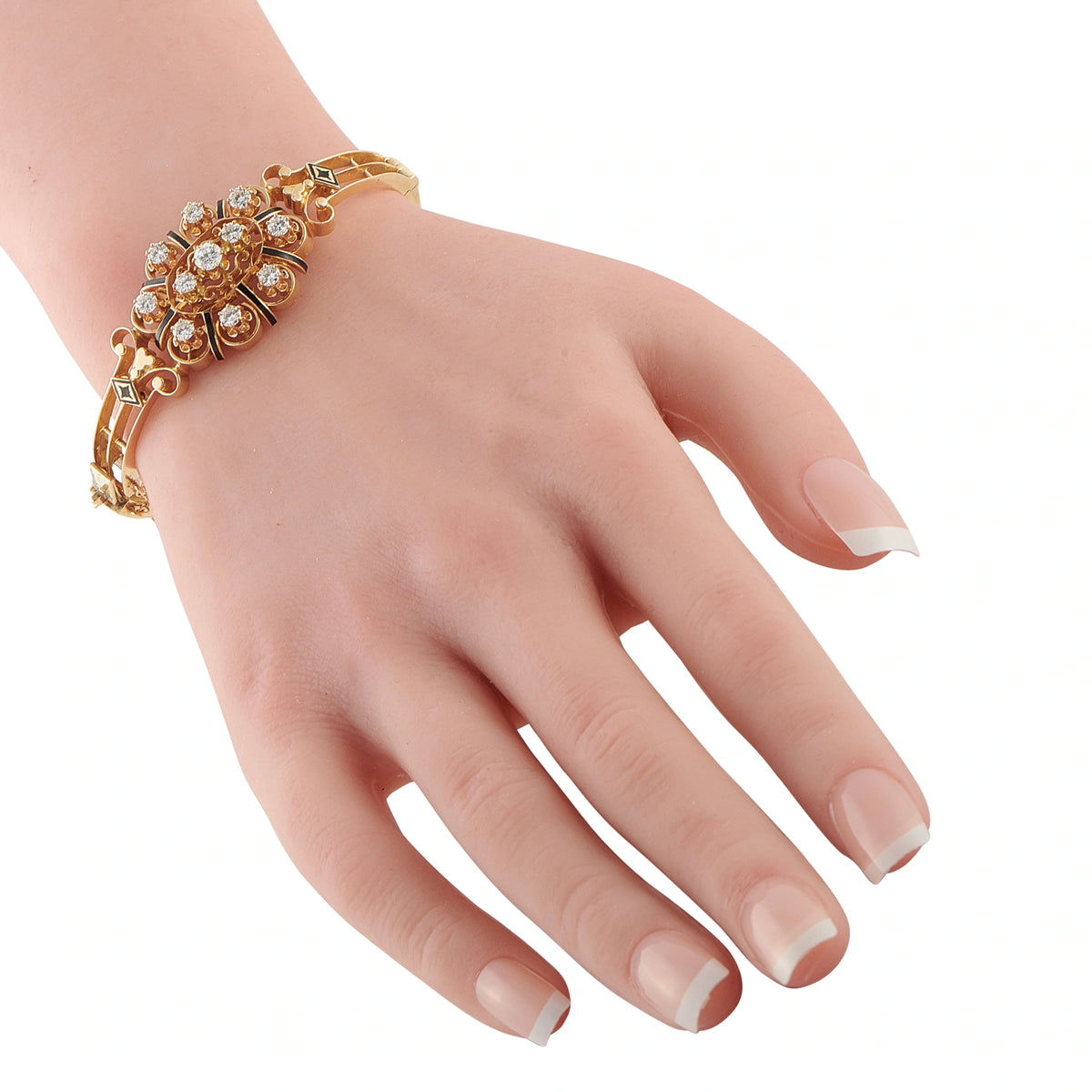 14K yellow gold diamond bracelet on wrist with enamel star motifs and round stones