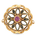 Gold-tone flower brooch with purple center gemstone and black enamel leaves