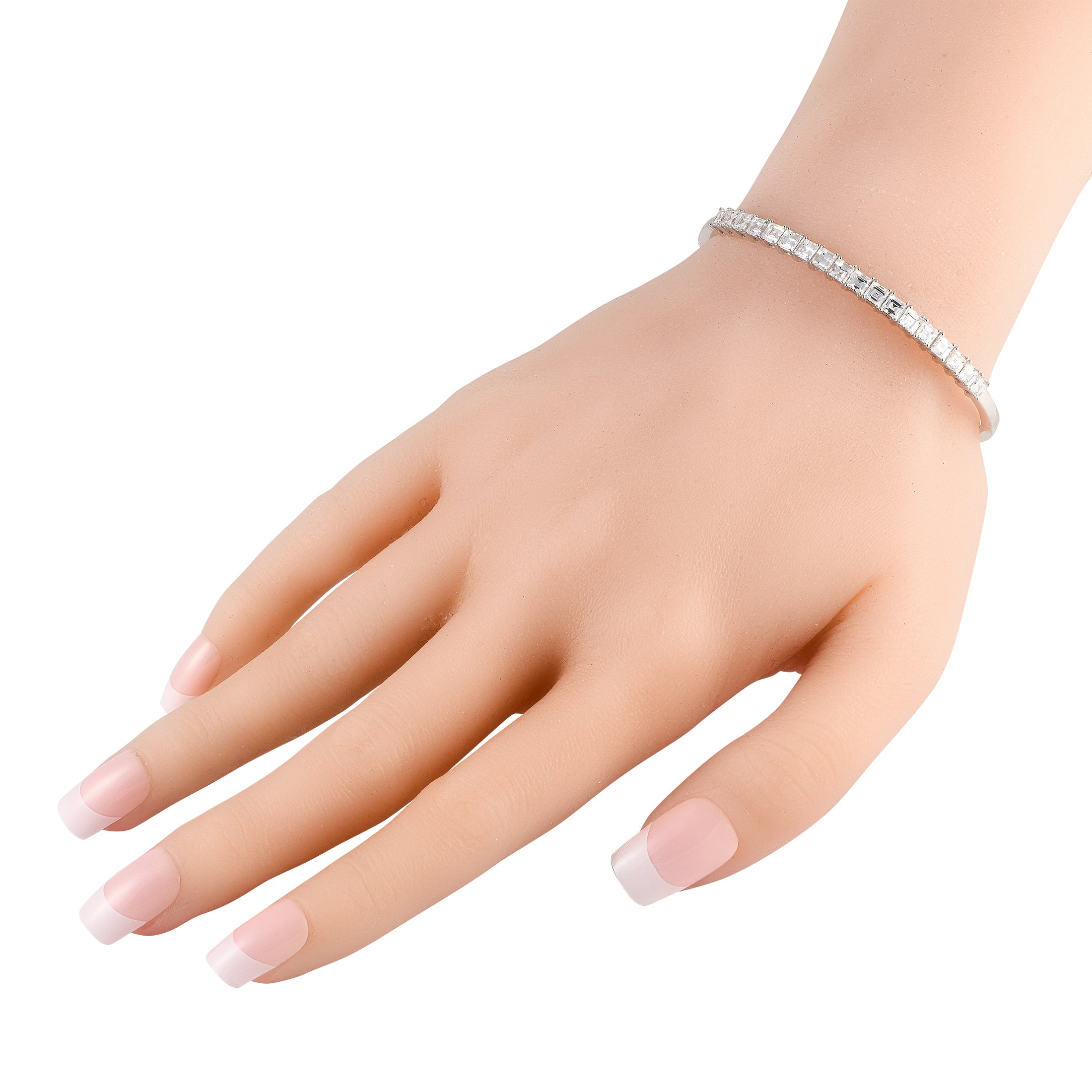 White gold diamond bracelet on wrist with baguette stone design