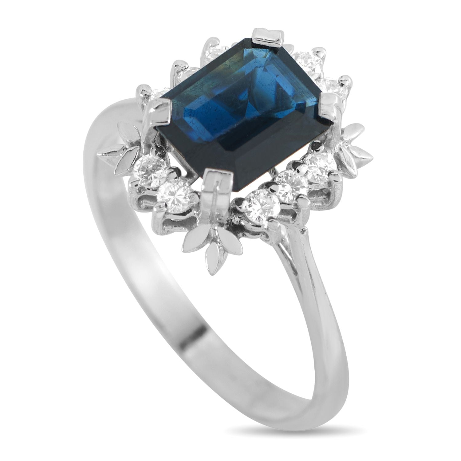 18K White Gold 0.20ct Diamond and Sapphire Ring - This dazzling ring is an eye-catching piece that will never go out of style. At the center of the ornate 18K White Gold setti