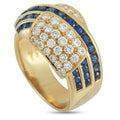 Yellow gold ring with oval diamond cluster and blue sapphire row around