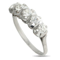Platinum diamond ring with linked round stones in shared prong setting