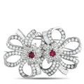 Diamond and ruby bow-and-bloom brooch with red centers, silver-tone pave design