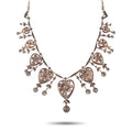 Rose gold diamond necklace with heart-shaped filigree and dangling floral details