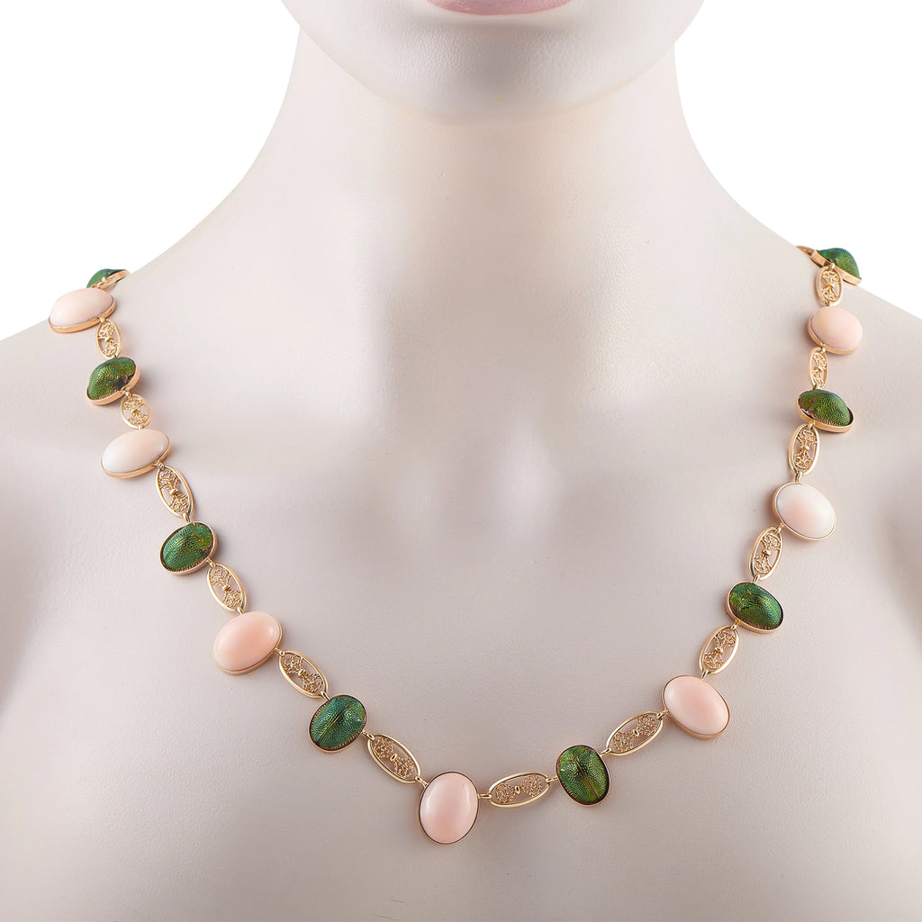 Rose gold tone necklace on mannequin with green and pink oval cabochons and ornate links