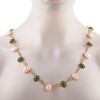 Rose gold tone necklace on mannequin with green and pink oval cabochons and ornate links