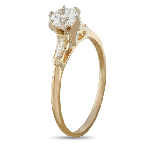 Yellow gold ring with large round diamond solitaire and two baguette side stones