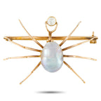 Rose gold-tone spider bar brooch with oval baroque pearl and small round diamond on top