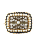 Antique gold brooch with pearl border, diamond accents, and dark enamel frame