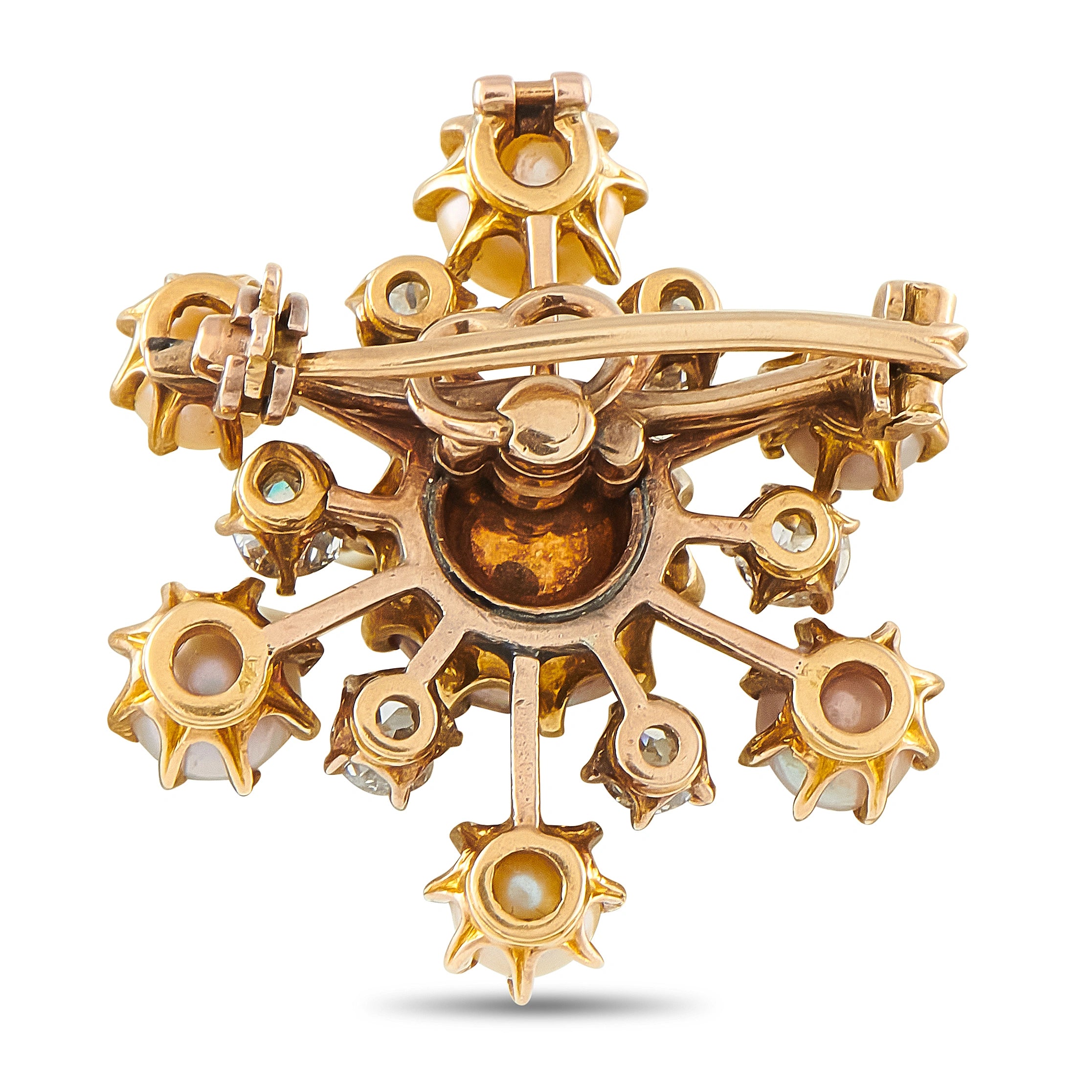 Back of rose gold starburst brooch with filigree prongs and pin clasp hardware