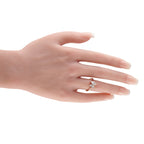 14K rose gold diamond cluster ring with marquise center stone on hand, prong-set