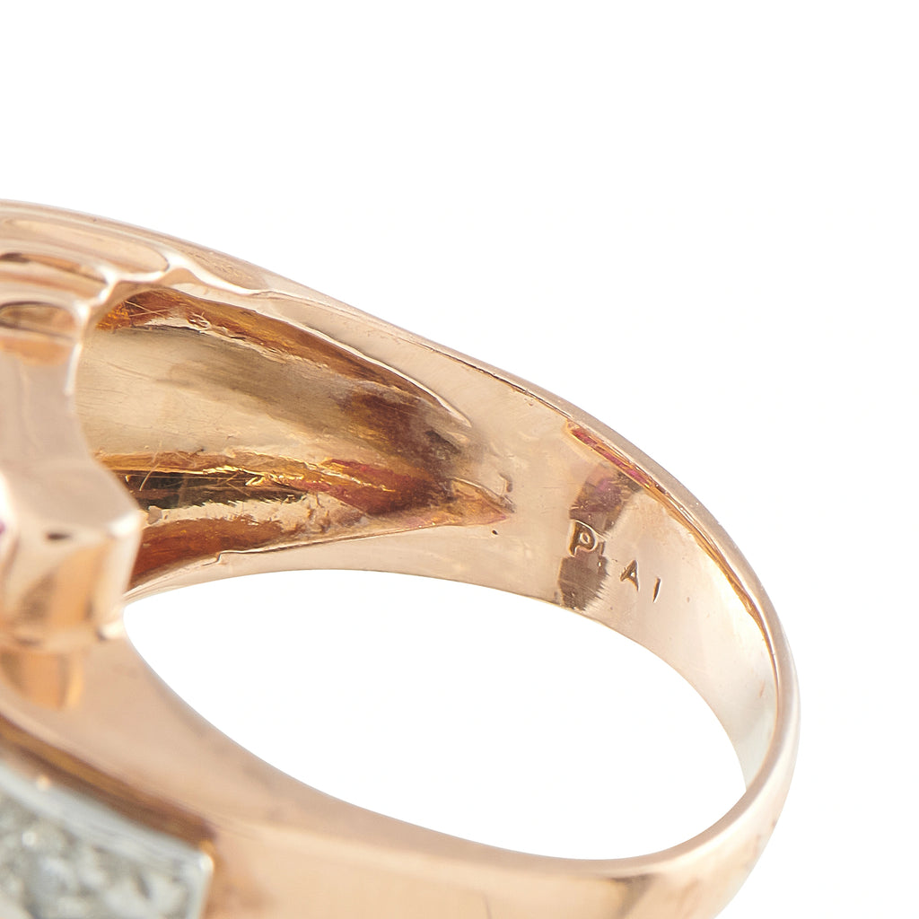 Rose gold ring band close-up with diamond detail and hallmark