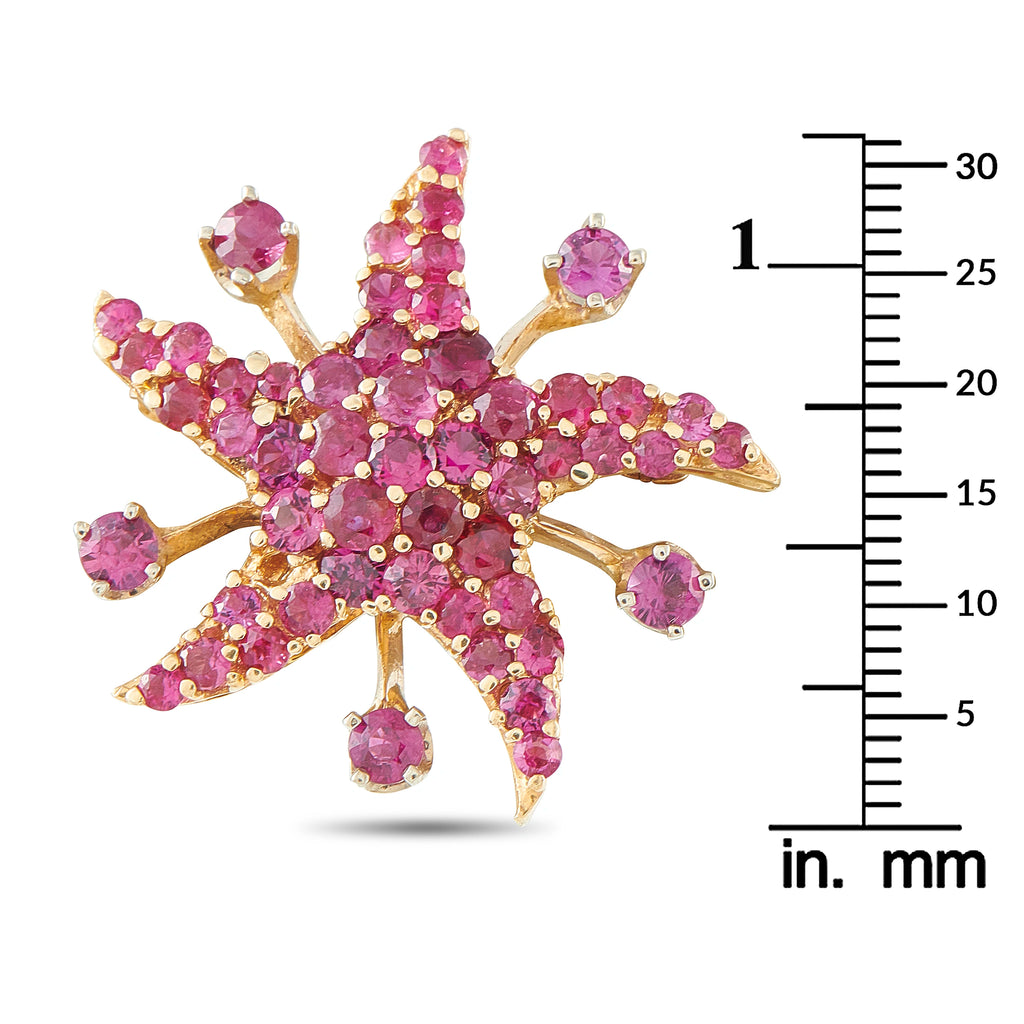 Star-shaped rose gold brooch with pink stones, shown with measuring scale (mm).