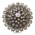Silver starburst brooch with central round diamond and prong-set sparkle accents