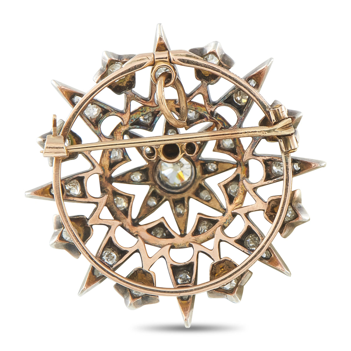 Diamond star brooch with rose-gold ring frame, silver prongs, and star-shaped accents