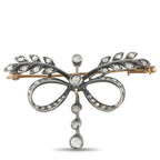 Diamond bow brooch with openwork metal, oval loops and dangling round stones