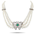 Multi-strand pearl necklace with silver-toned filigree emerald and diamond centerpiece