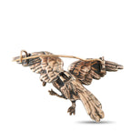 Gold-tone bird brooch with detailed wings and legs, hinge clasp and pin back