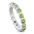 14K white gold eternity band with round green gemstones in bezel settings
