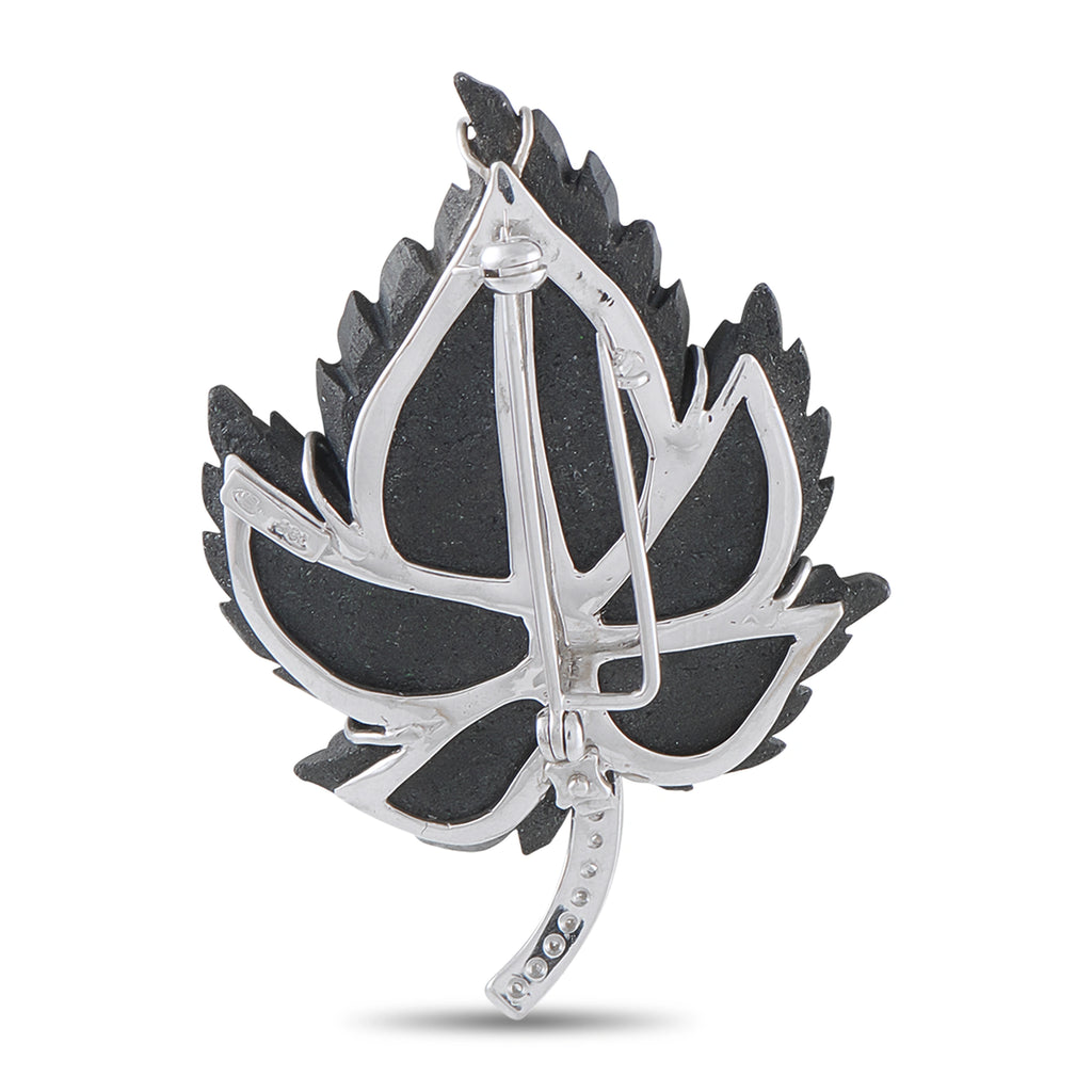 Back view leaf brooch in white gold with green stone leaf and diamond trim