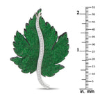 Green leaf brooch in white gold with diamond border, shown with inch/mm scale