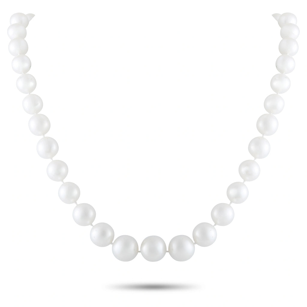 White pearl bead necklace with evenly spaced round pearls, clasp visible at front