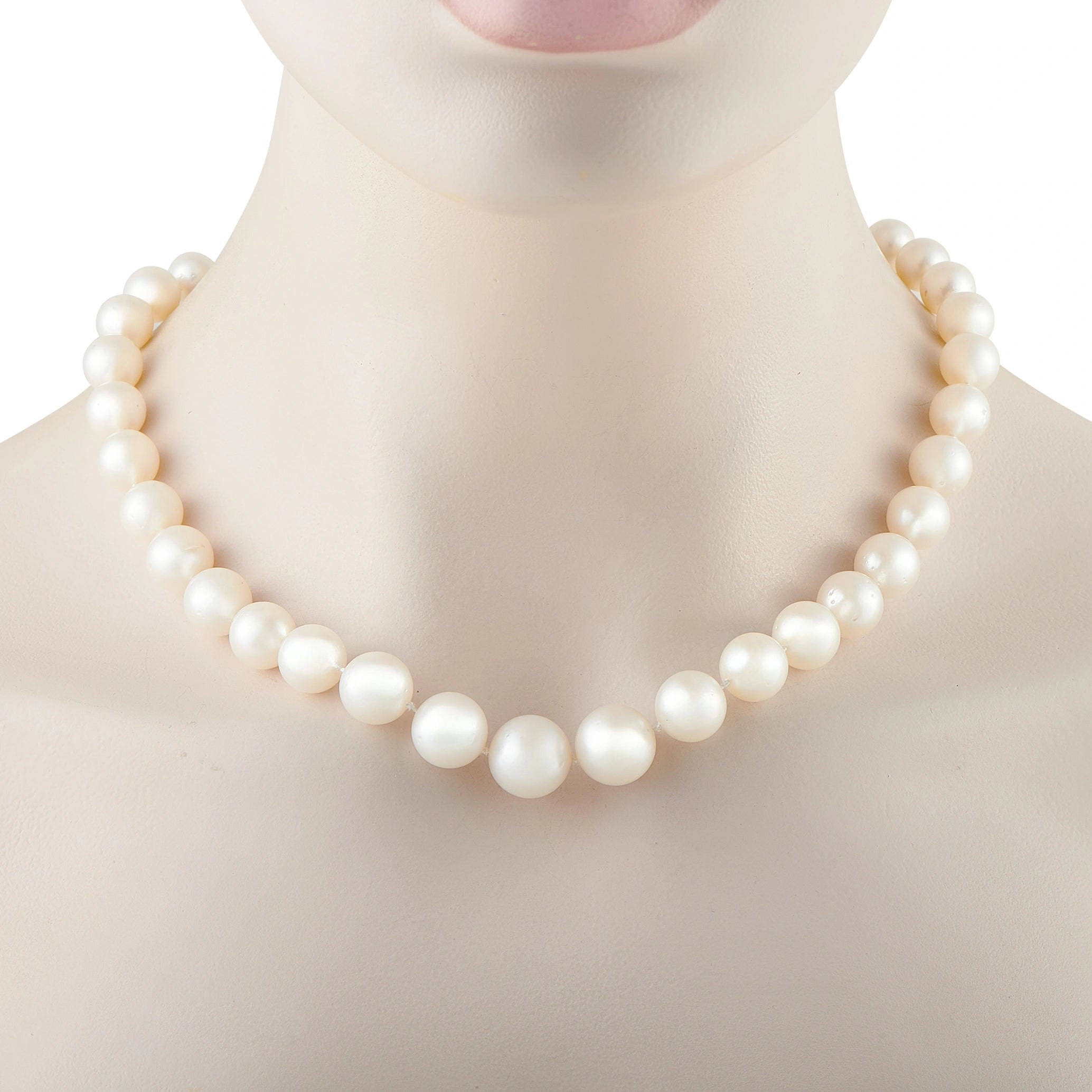 Round white pearl bead necklace on mannequin neckline, strand and clasp end visible