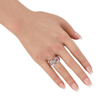 14K white gold ring with pink center stone and small side diamonds, on finger
